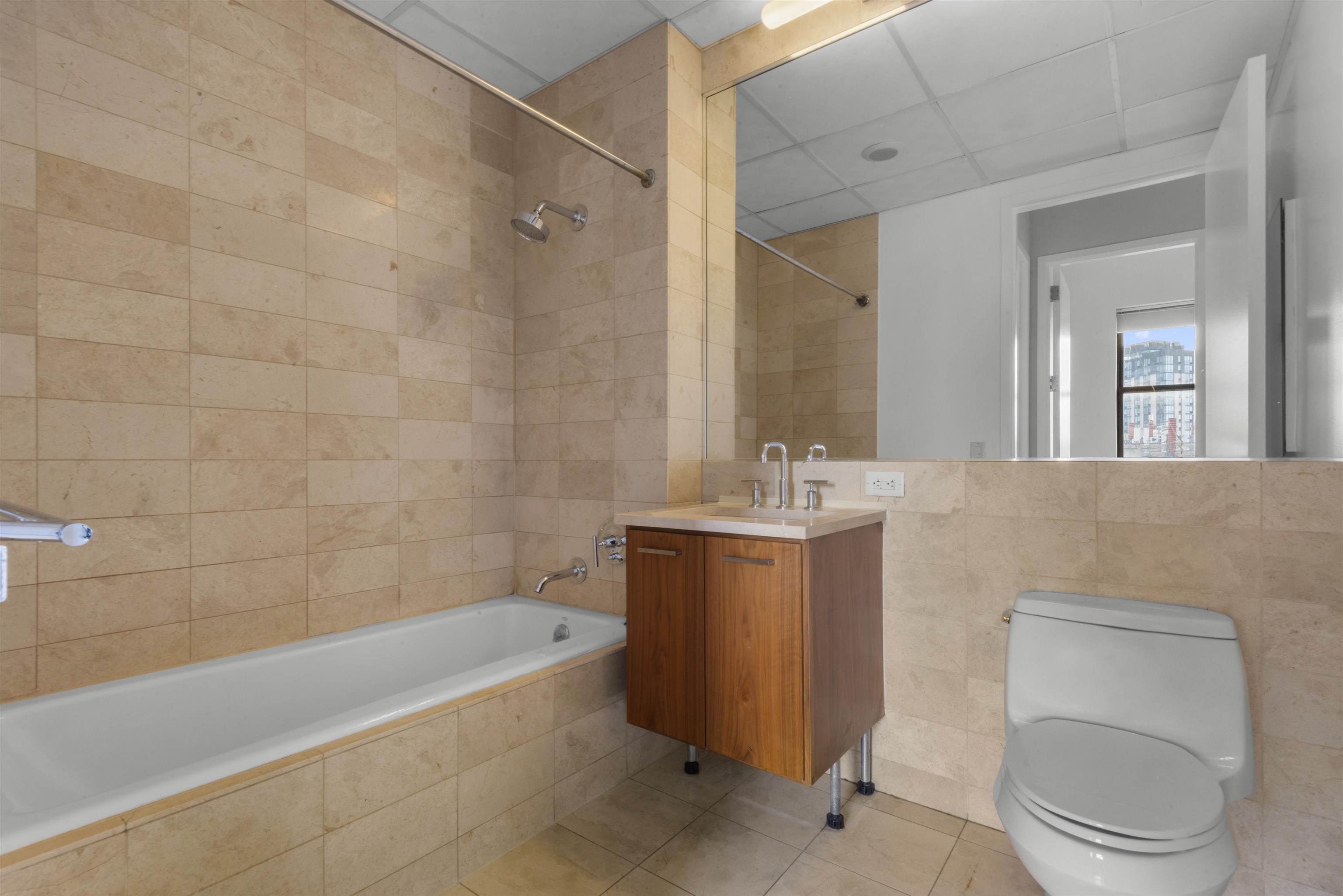 4 Beacon Way, Unit 301 Jersey City, NJ 07304 - Photo 5 of 26 a bathroom with a sink a toilet and bathtub