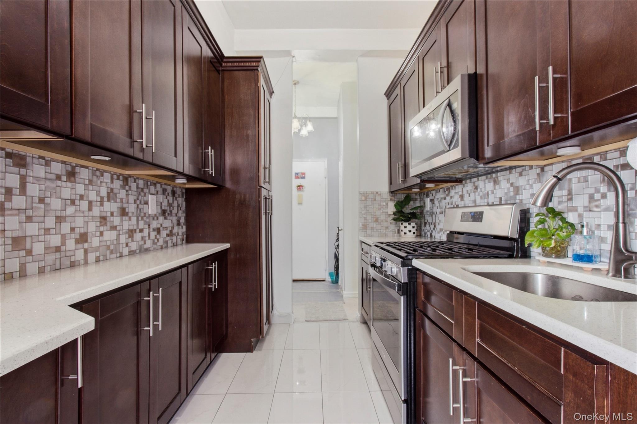 245 Rumsey Road, Unit 2S Yonkers, NY 10701 - Photo 12 of 21 a kitchen with stainless steel appliances granite countertop a sink stove and cabinets