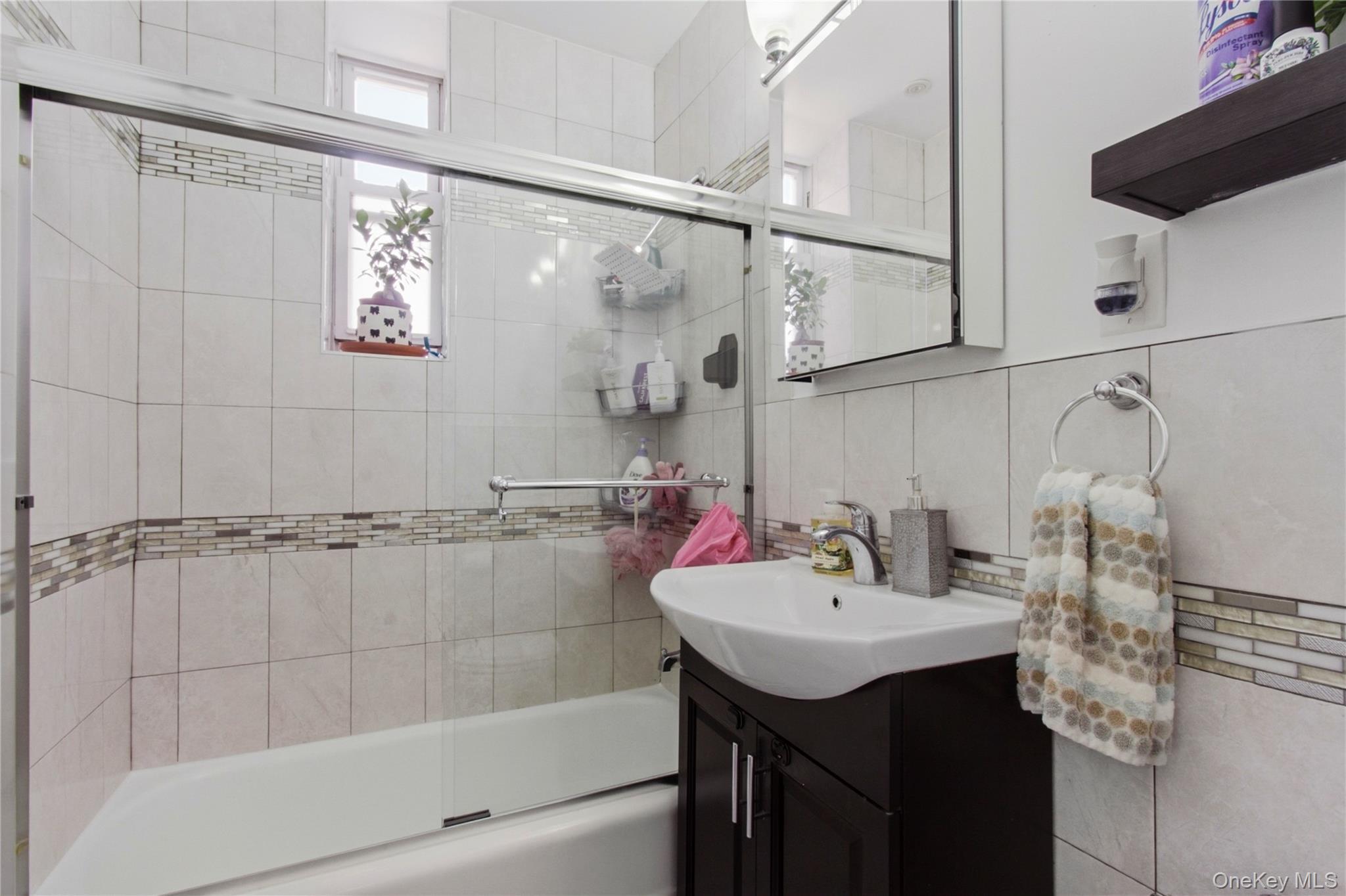 245 Rumsey Road, Unit 2S Yonkers, NY 10701 - Photo 15 of 21 a bathroom with a sink mirror and shower