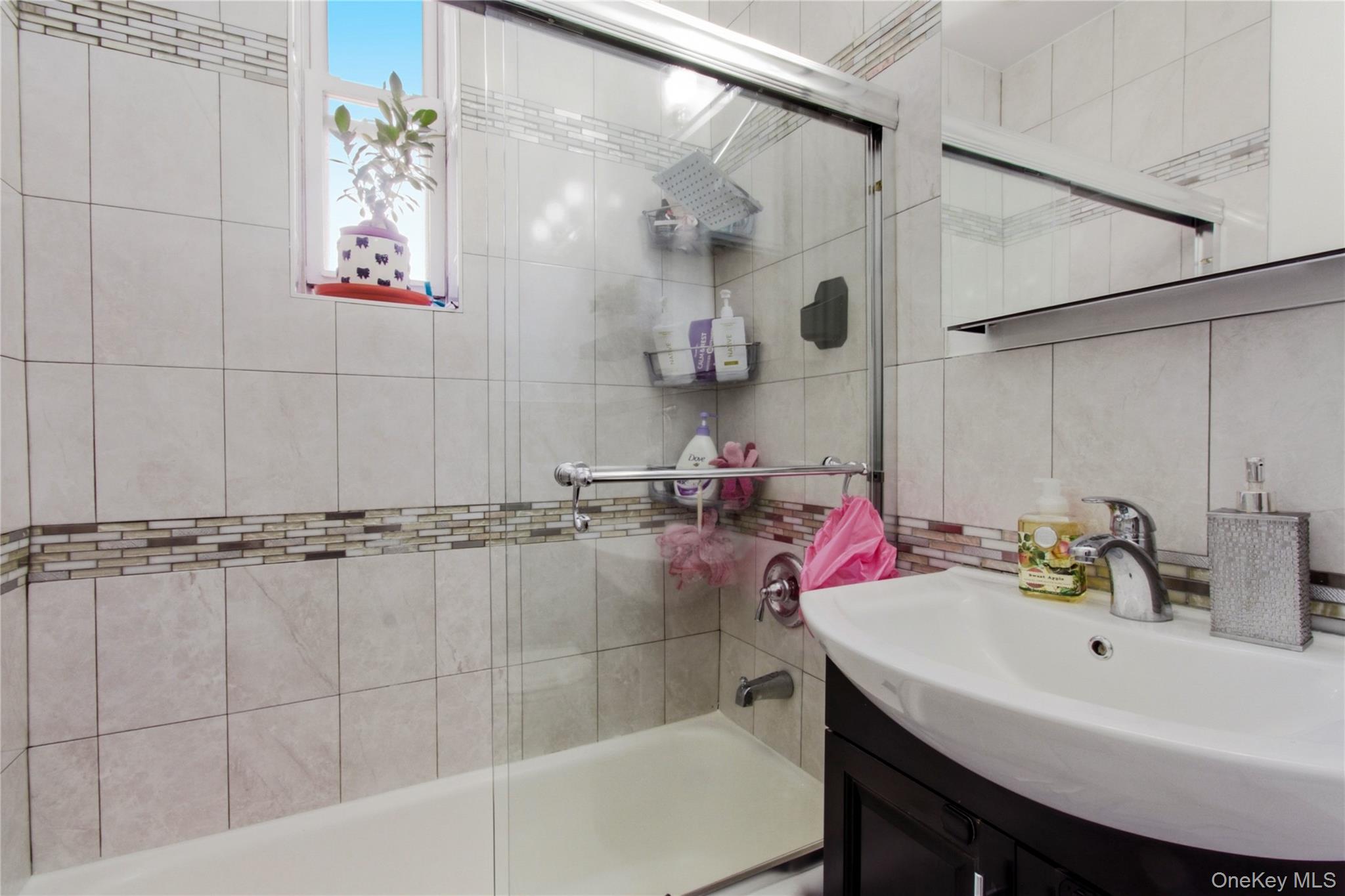 245 Rumsey Road, Unit 2S Yonkers, NY 10701 - Photo 16 of 21 a bathroom with a sink and a mirror