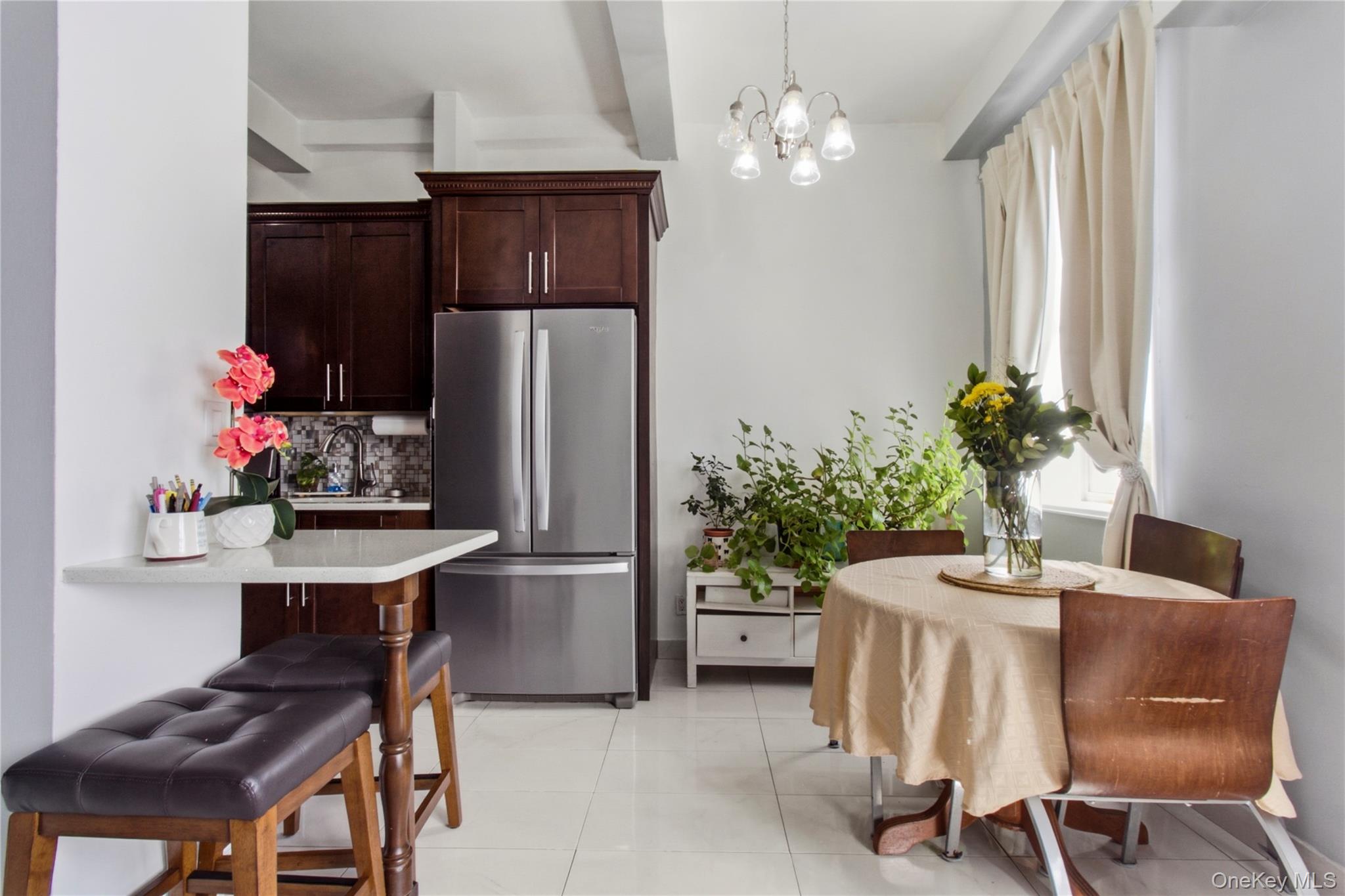 245 Rumsey Road, Unit 2S Yonkers, NY 10701 - Photo 9 of 21 a dining room with furniture and chandelier