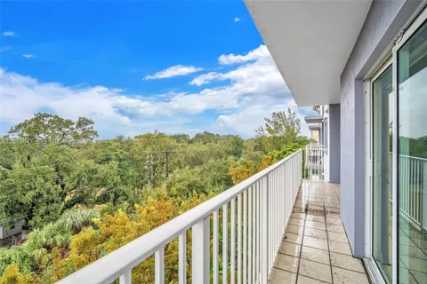 a view of a balcony with wooden floor