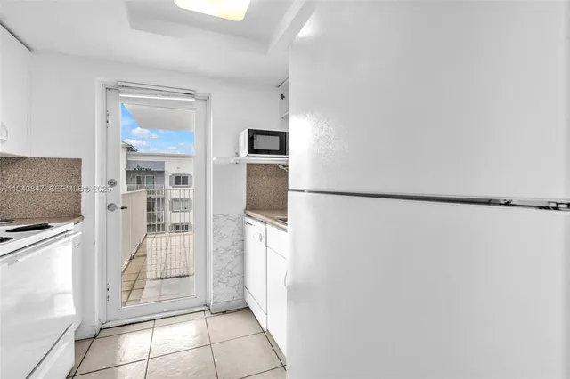 a view of a kitchen with refrigerator and cabinet