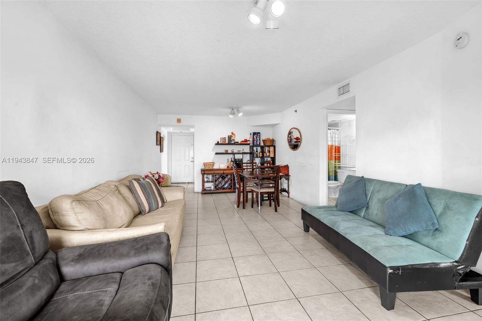 2475 Northwest 16th St Road, Unit 601 Miami, FL 33125 - Photo 26 of 26 a living room with furniture and white walls