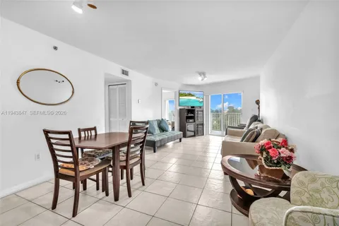 a dining room with furniture and a mirror