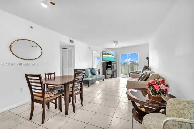 a dining room with furniture and a mirror