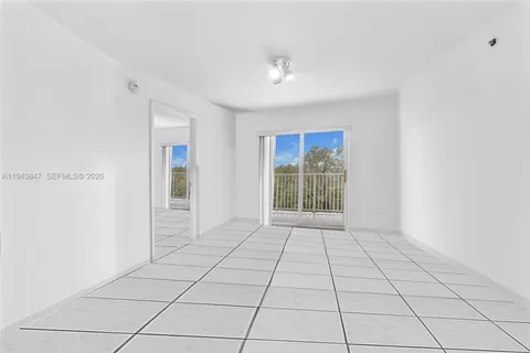 a view of an empty room with glass door