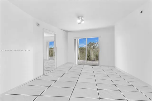 a view of an empty room with glass door