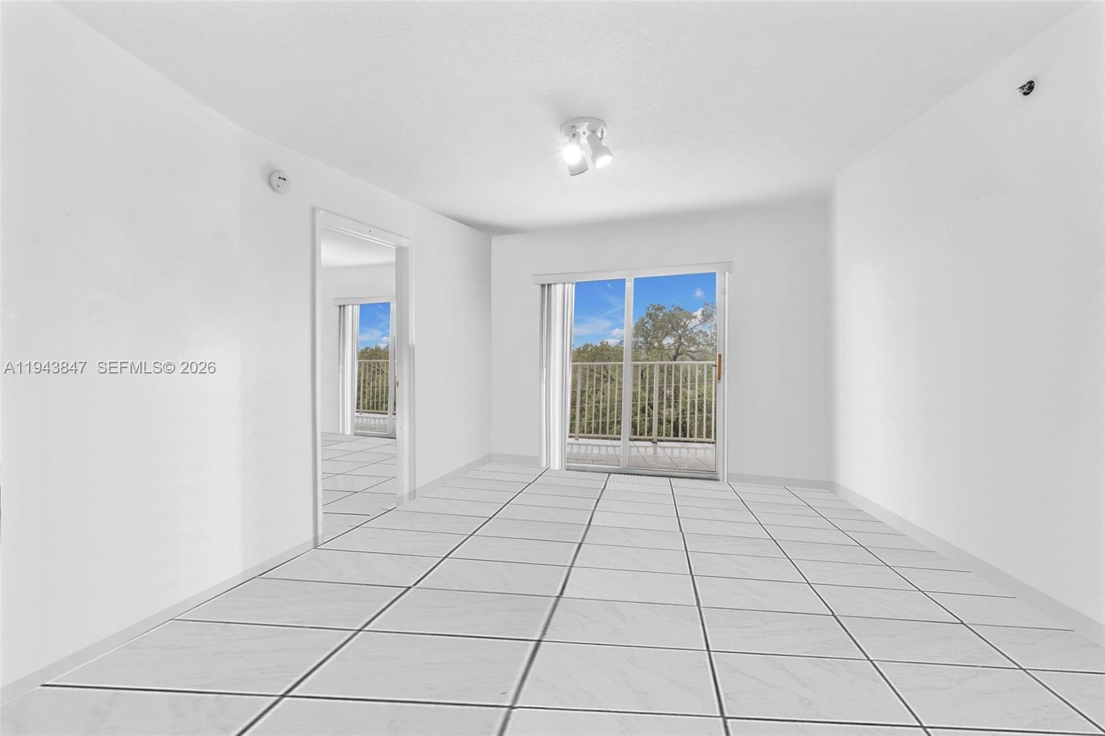 2475 Northwest 16th St Road, Unit 601 Miami, FL 33125 - Photo 5 of 26 a view of an empty room with glass door