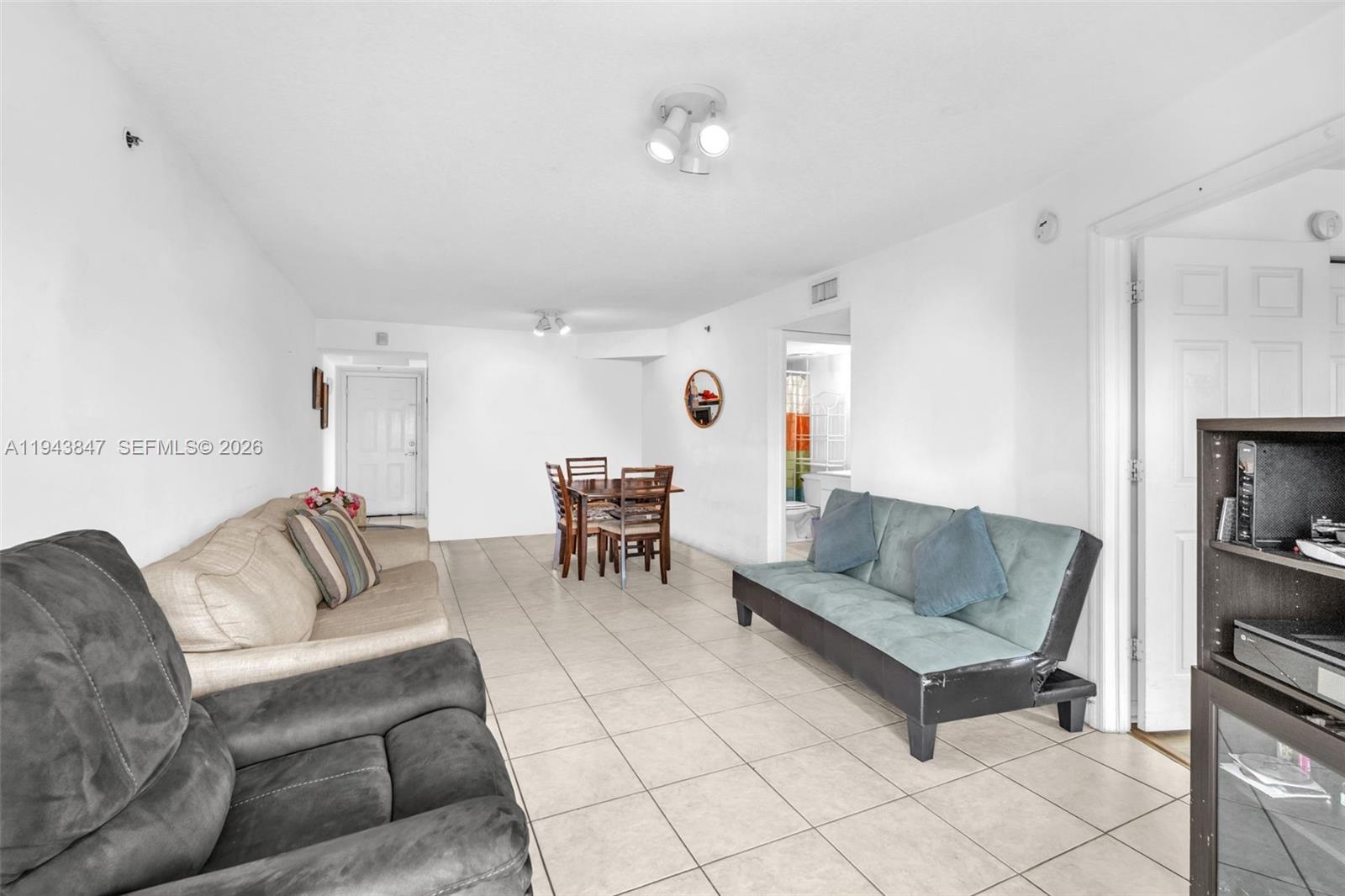 2475 Northwest 16th St Road, Unit 601 Miami, FL 33125 - Photo 6 of 26 a living room with furniture and a couch