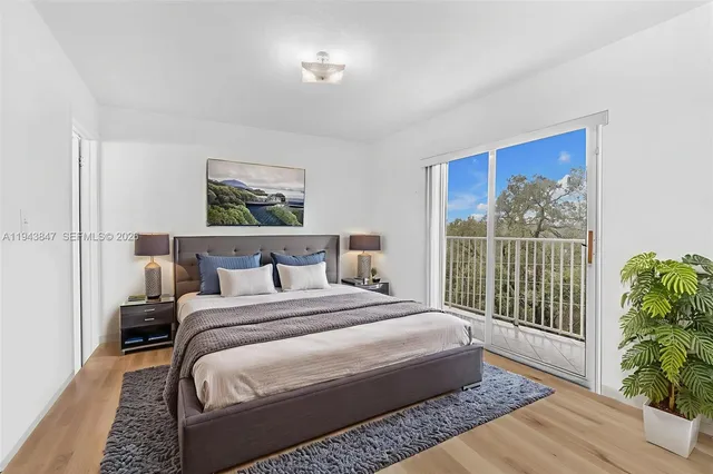 a bedroom with a large bed and a painting on the wall