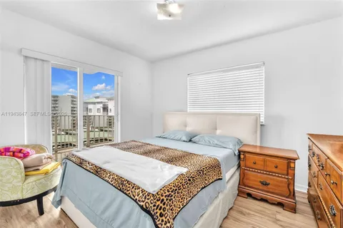 a bedroom with a bed and a dresser next to a window