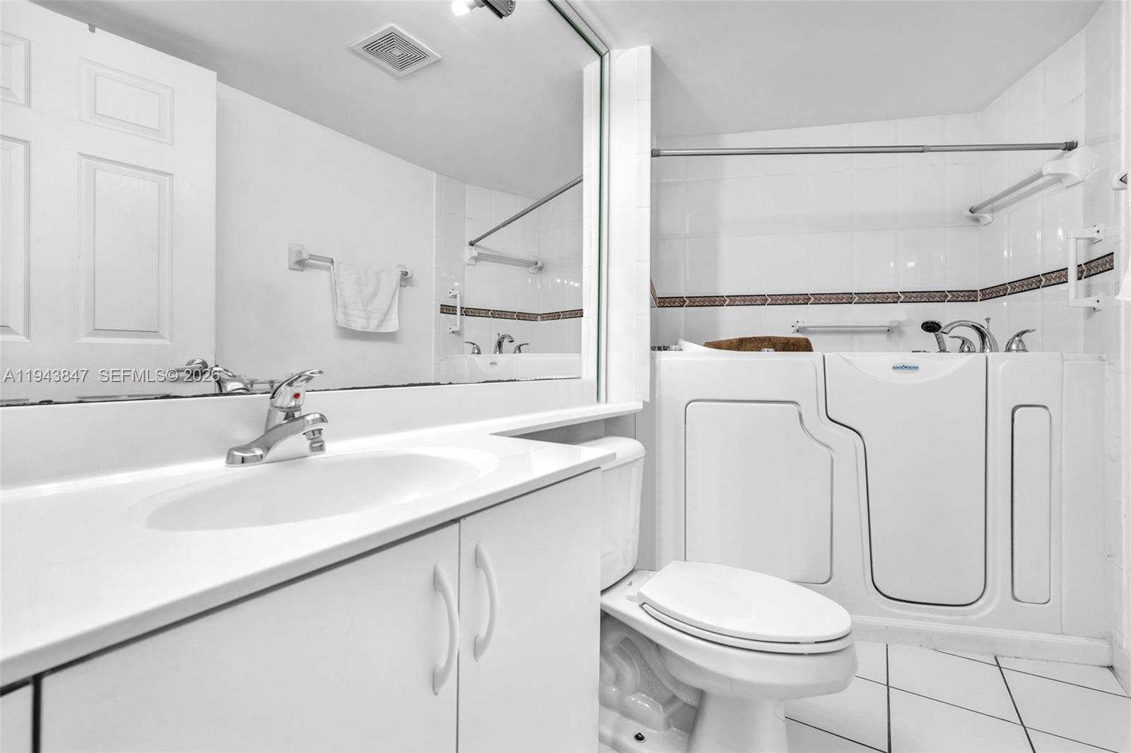 2475 Northwest 16th St Road, Unit 601 Miami, FL 33125 - Photo 10 of 26 a bathroom with a sink toilet and shower