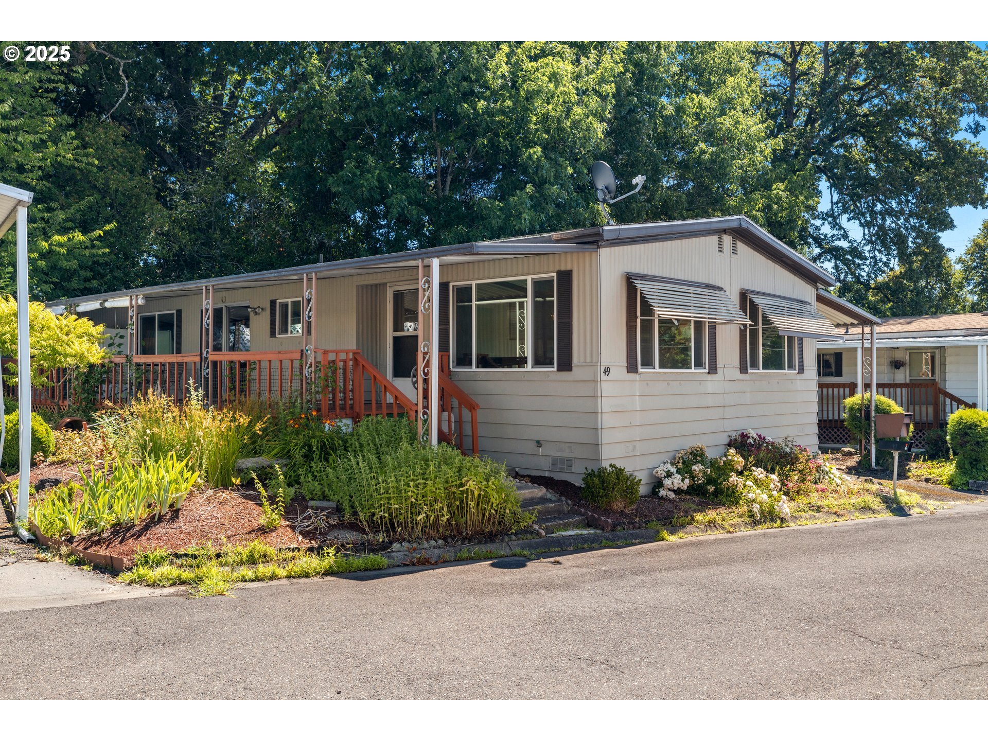 3405 Southeast Vineyard Road, Unit 49 Milwaukie, OR 97267 - Photo 1 of 43 a front view of a house with a yard and outdoor seating