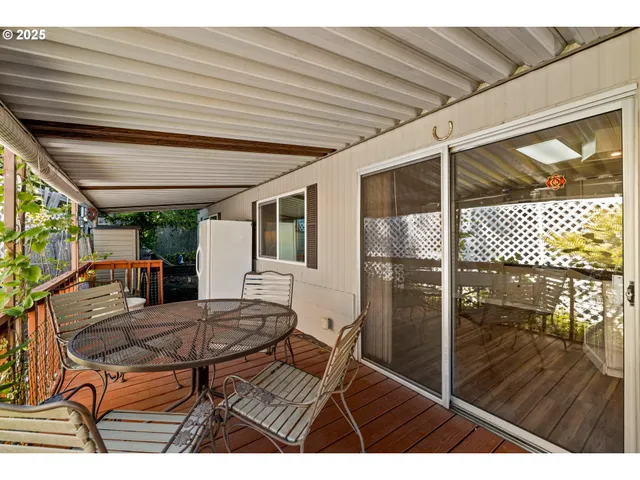 a balcony view with a table and chairs