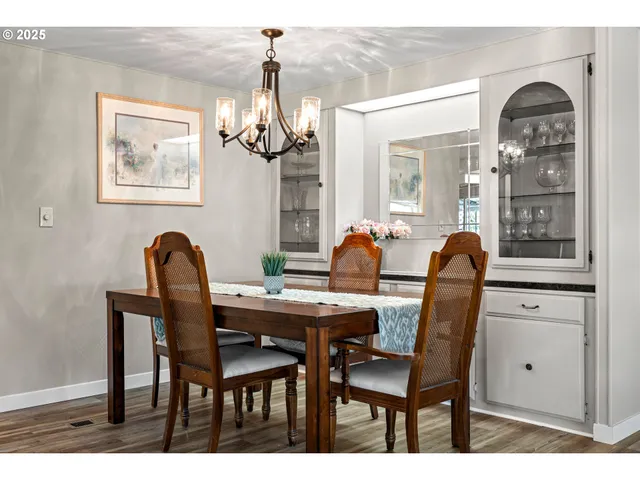 a view of a dining room with furniture and chandelier