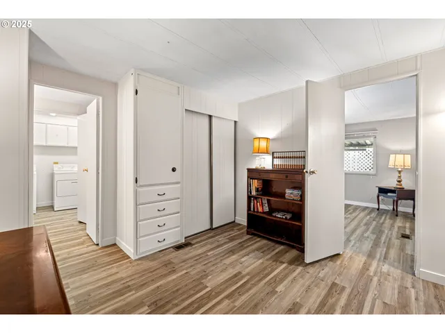 a view interior of kitchen and hall with wooden floor
