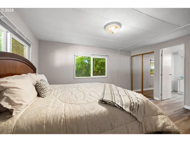 a bedroom with a bed and a large window