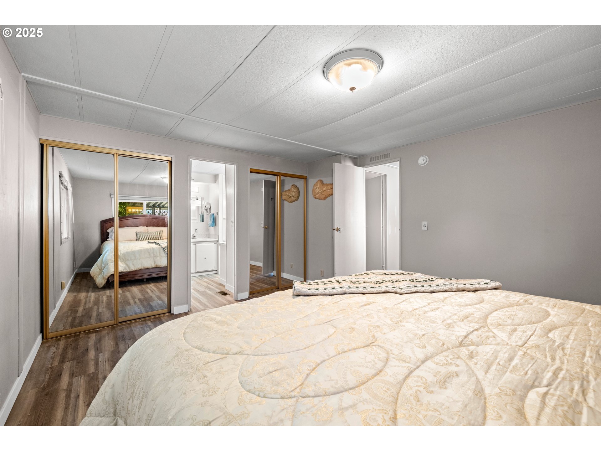 3405 Southeast Vineyard Road, Unit 49 Milwaukie, OR 97267 - Photo 37 of 43 a bedroom with a bed and a large mirror