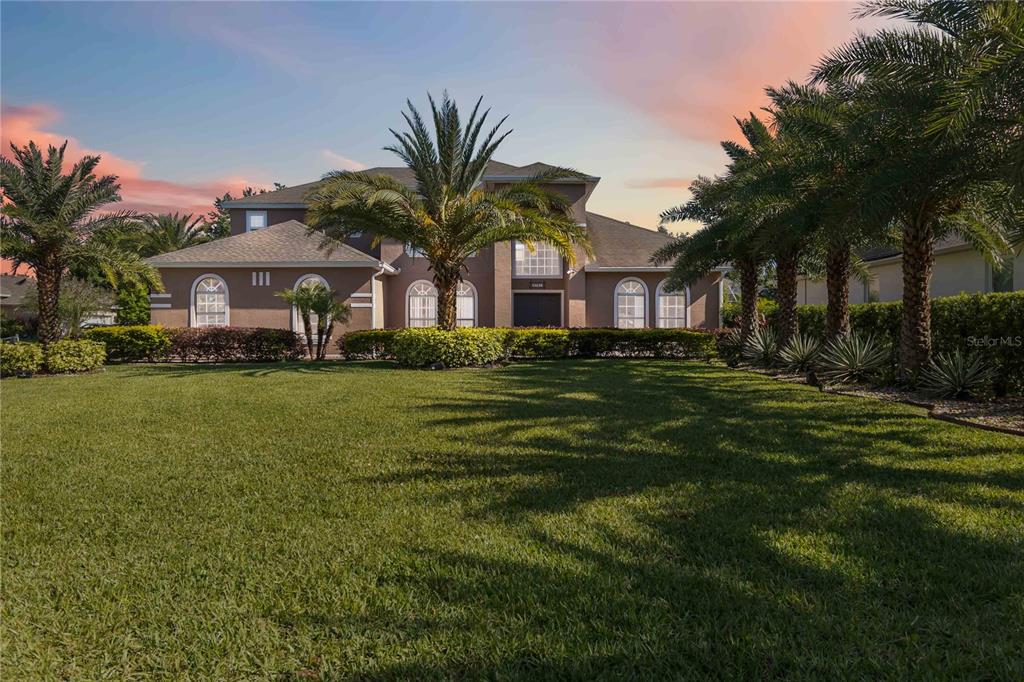 a front view of house with yard and green space