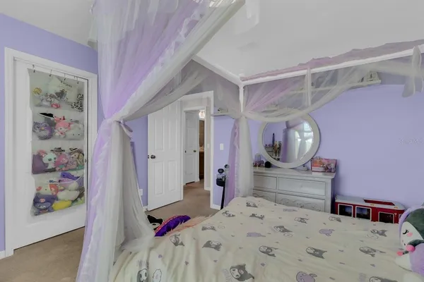 a living room with a bed and a window