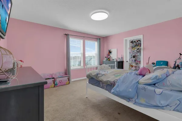 a bedroom with a bed and window