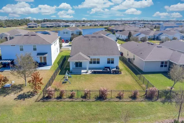 a living room with patio furniture and a potted plant