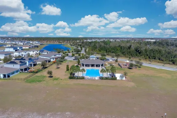 a swimming pool with outdoor seating and yard