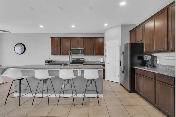 a living room with furniture and a view of kitchen