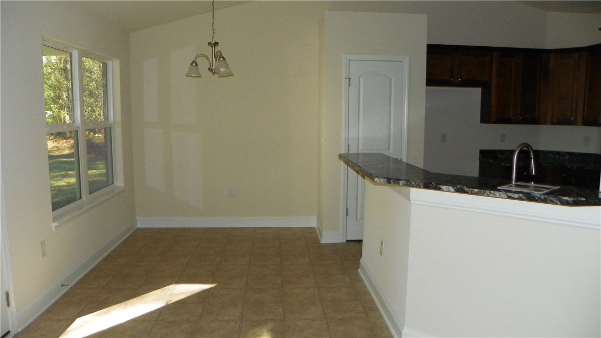 88100 Maybourne Road Yulee, FL 32097 - Photo 7 of 8 a bathroom with a granite countertop sink and a mirror