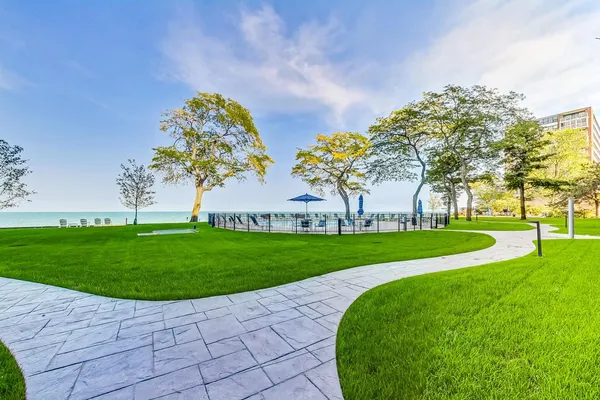a view of a playground with a garden and trees