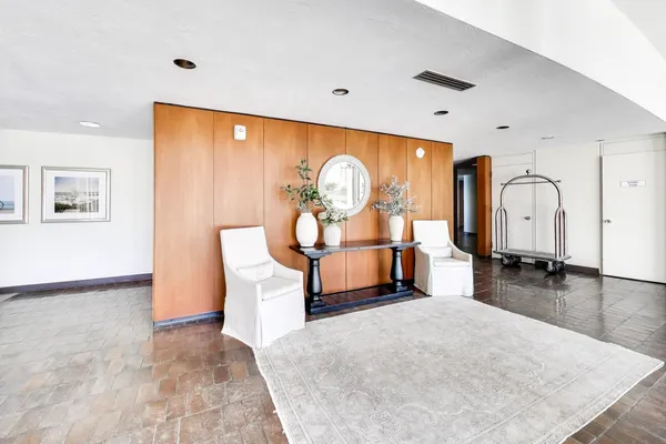 a living room with furniture a rug and a large window