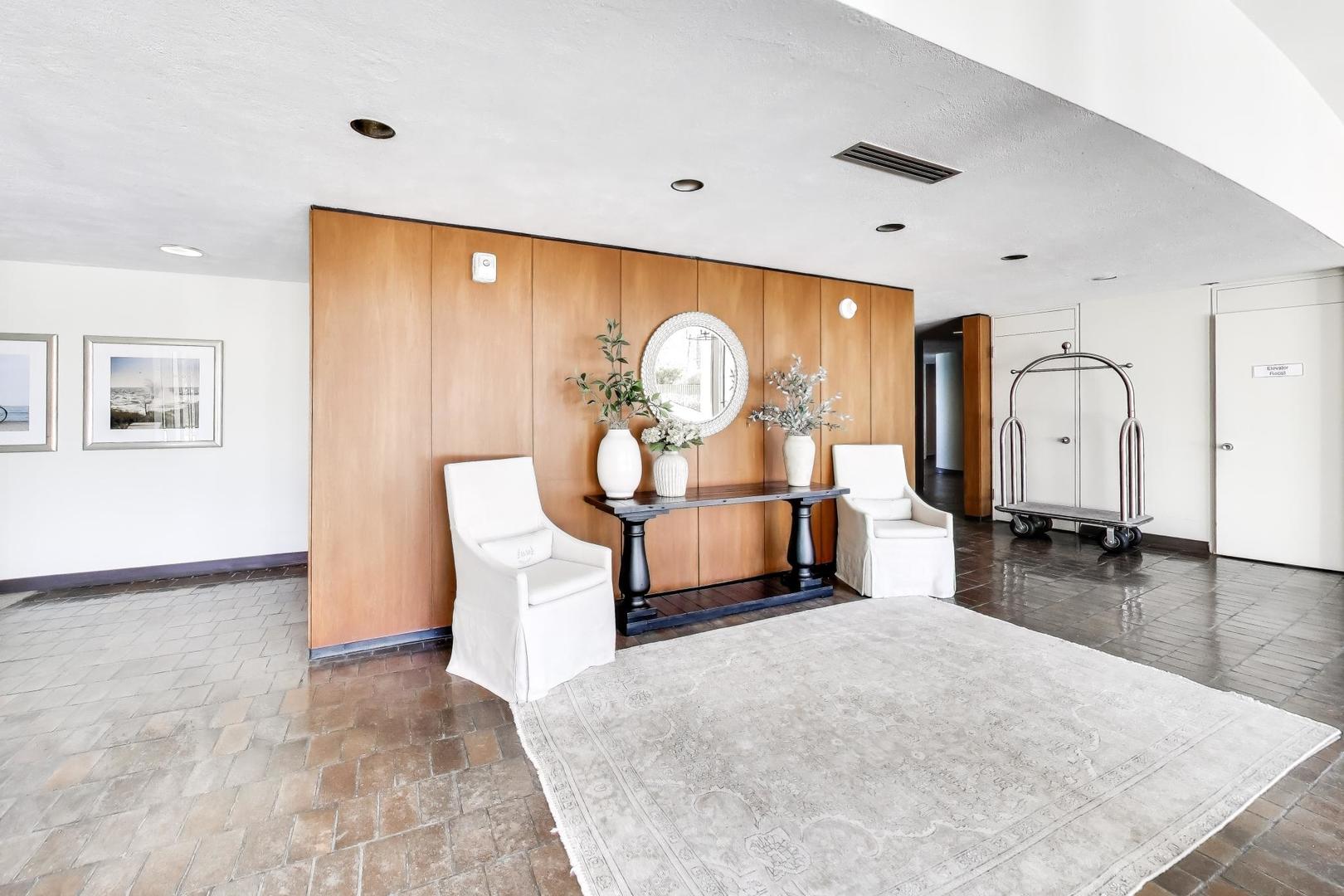 1630 Sheridan Road, Unit 7K Wilmette, IL 60091 - Photo 6 of 28 a living room with furniture a rug and a large window