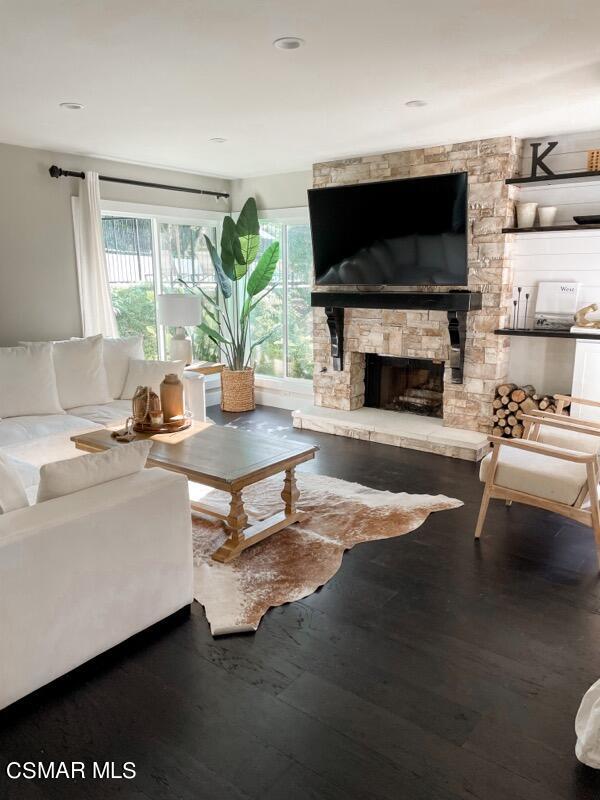 979 Thistlegate Road Oak Park, CA 91377 - Photo 1 of 19 a living room with furniture a flat screen tv and a fireplace