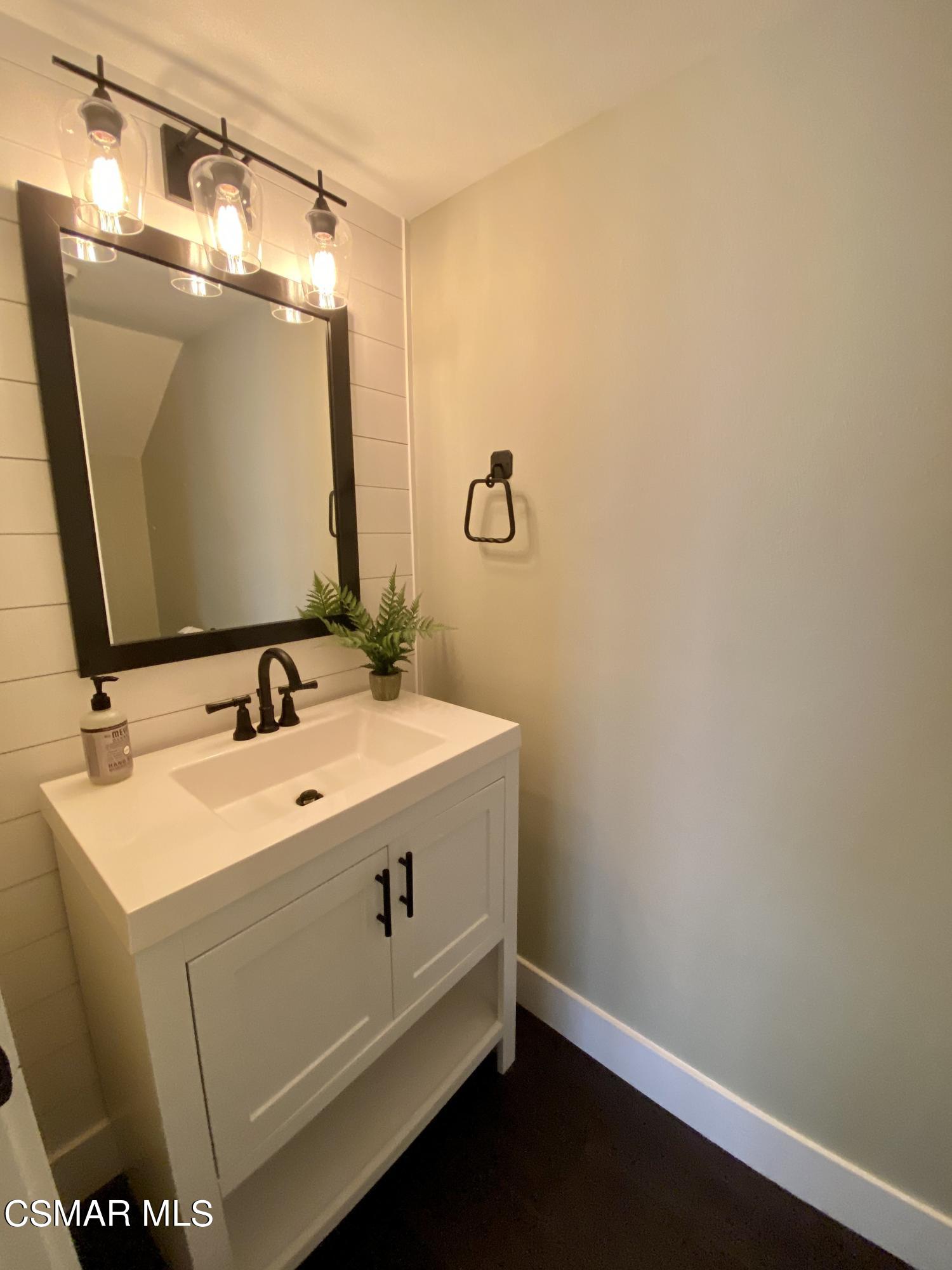 979 Thistlegate Road Oak Park, CA 91377 - Photo 13 of 19 a bathroom with a sink and a mirror