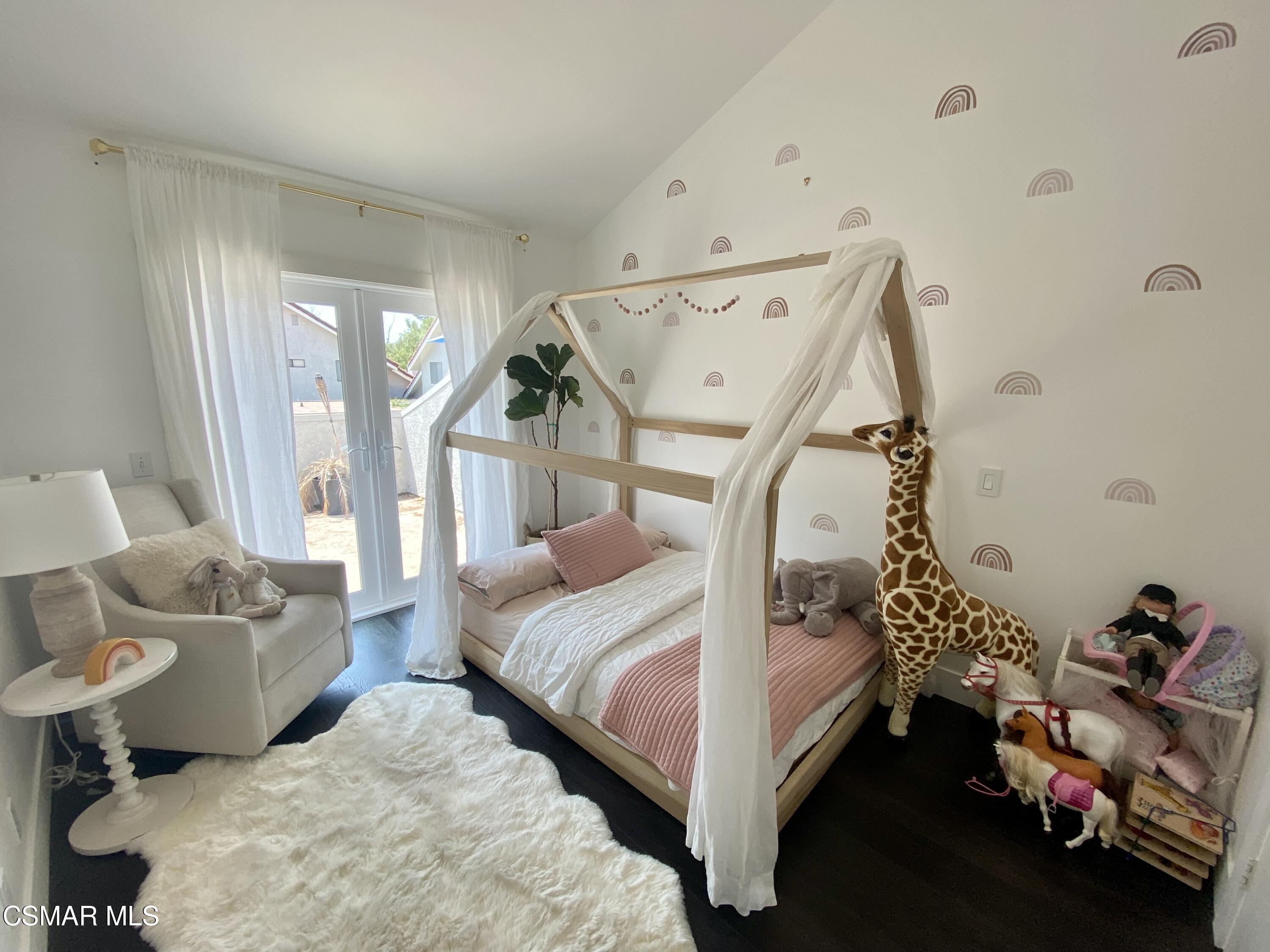 979 Thistlegate Road Oak Park, CA 91377 - Photo 15 of 19 a bedroom with a bed and a chandelier
