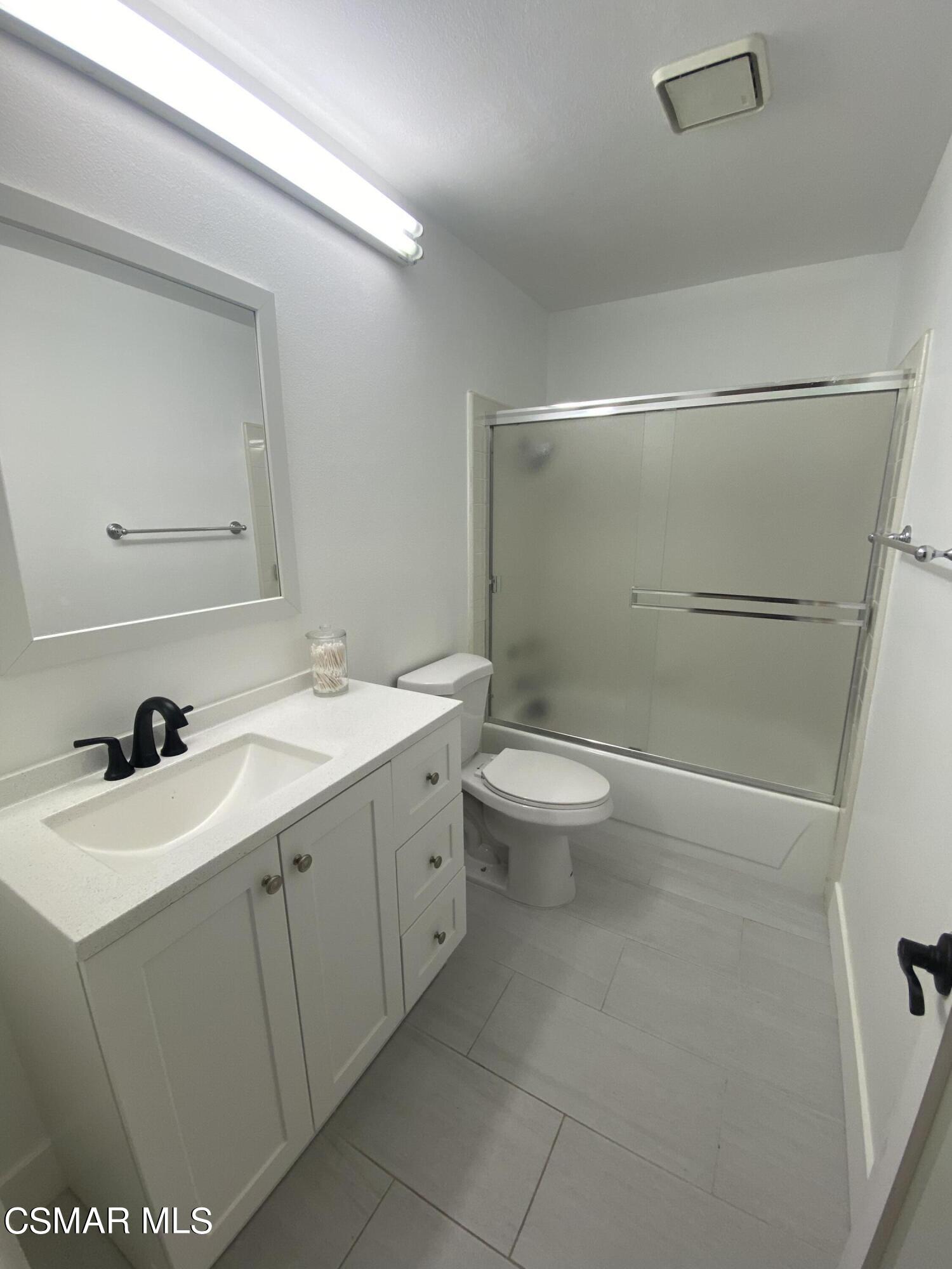 979 Thistlegate Road Oak Park, CA 91377 - Photo 16 of 19 a bathroom with a sink toilet and shower