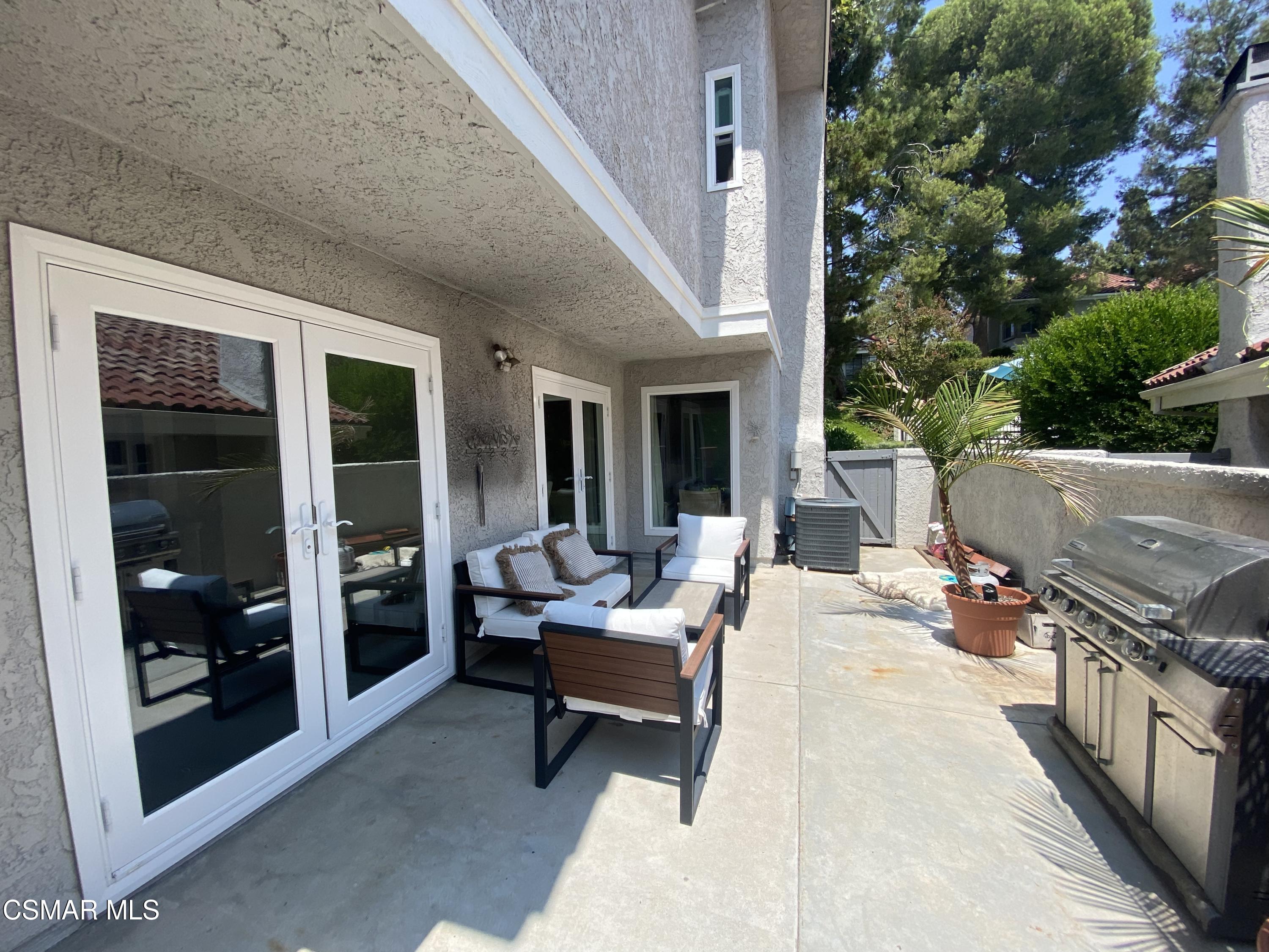 979 Thistlegate Road Oak Park, CA 91377 - Photo 19 of 19 a outdoor space with patio the couches and a potted plant on a table