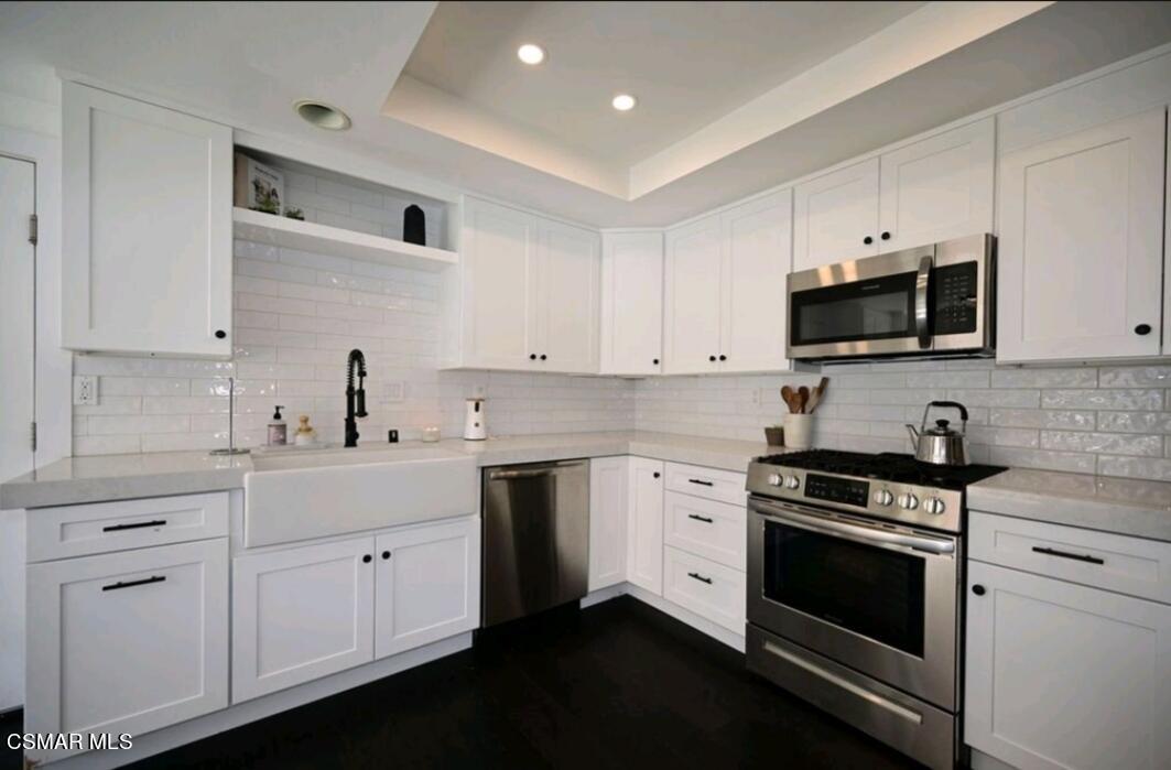 979 Thistlegate Road Oak Park, CA 91377 - Photo 8 of 19 a kitchen with cabinets stainless steel appliances and sink