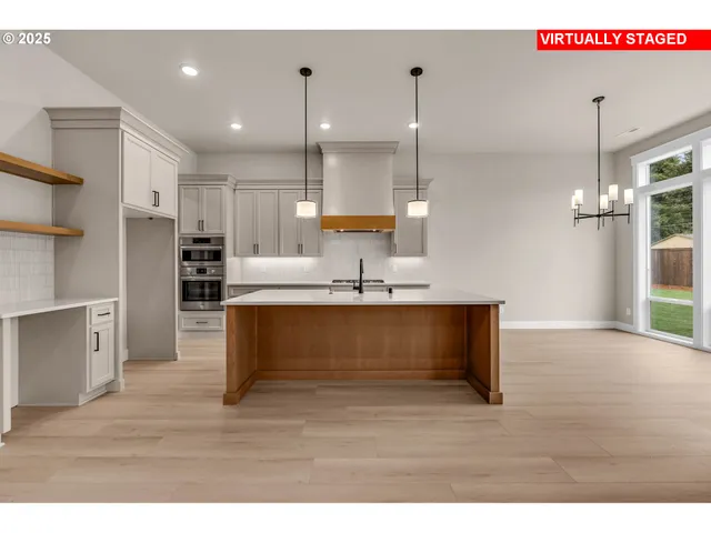 a view of kitchen with refrigerator microwave and wooden floor