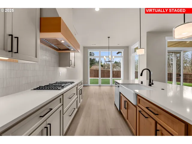 a open kitchen with stainless steel appliances granite countertop a stove and a sink