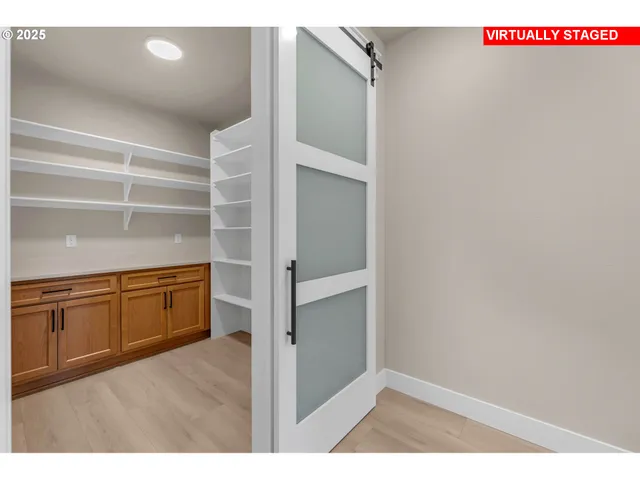 a kitchen with cabinets and wooden floor