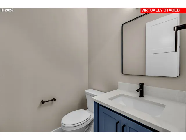 a bathroom with a sink a toilet and mirror