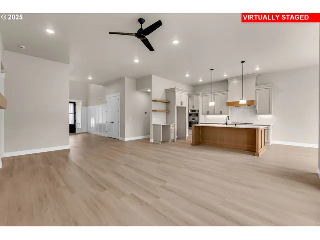 a view of a kitchen with a stove top oven a refrigerator with wooden floor