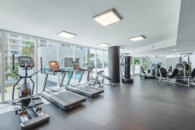 a living room with furniture and floor to ceiling window