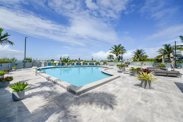 a view of swimming pool outdoor seating and city view