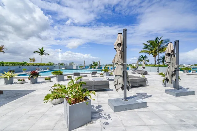 a backyard of a house with a table and chairs