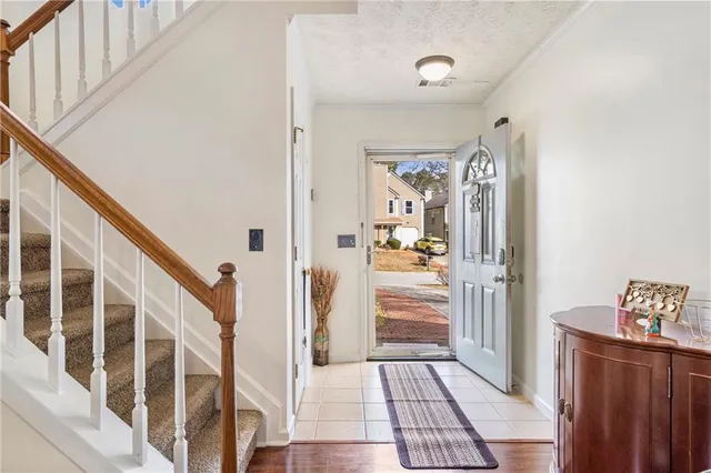 a view of an entryway with wooden floor and windows