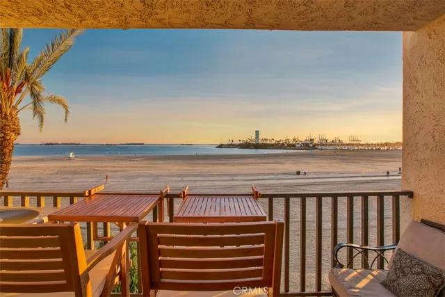 a view of a balcony with wooden floor and outdoor seating