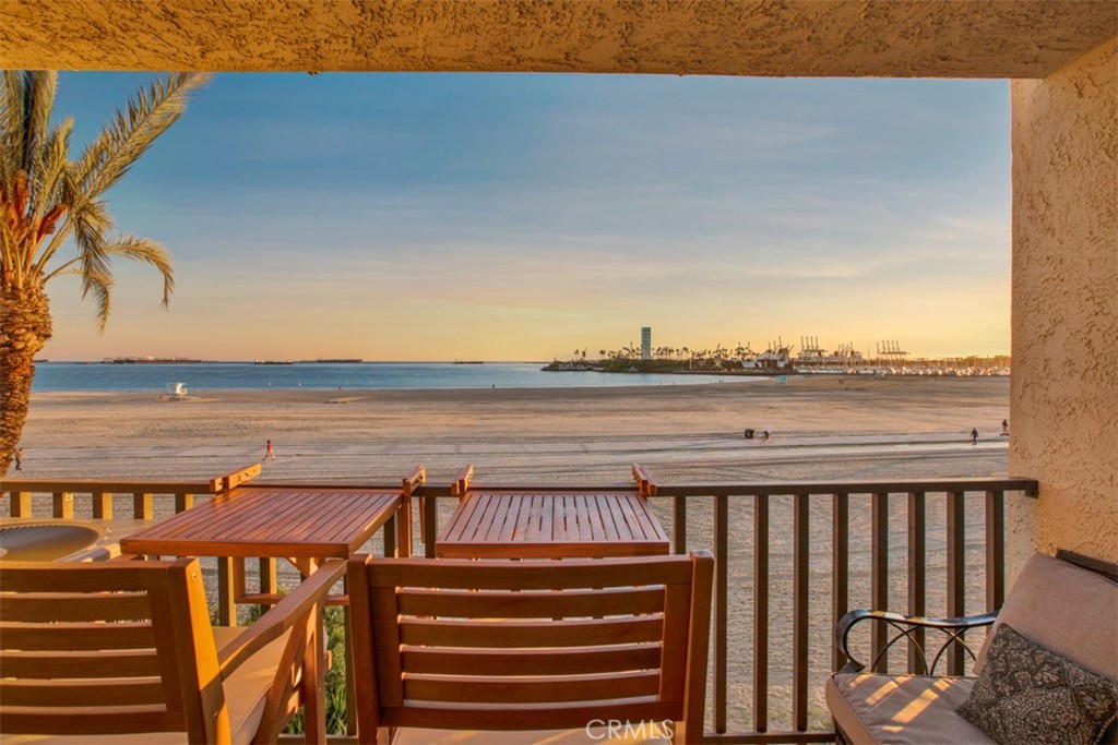 a view of a balcony with wooden floor and outdoor seating